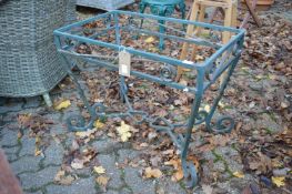 A green painted wrought iron table base.