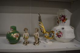 Decorative china to include a pair of figures of cherubs, a small Royal Worcester green ground jar