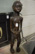 An African carved wood standing female figure.