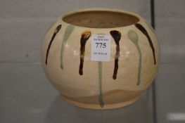 A Chinese earthenware pot with drip glazed decoration.