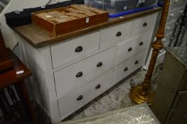 A large painted and stained chest of drawers.