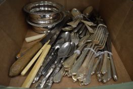 A quantity of plated flatware and a pair of decanter coasters.