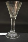 A Georgian wine glass with tapering bowl and plain stem.