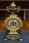 A good French bronze and gilt bronze mantel clock with urn shape finial and enamel numerals.