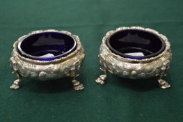 A pair of Victorian silver salts with blue glass liners.