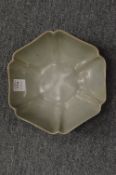A Chinese celadon glazed dish of lobed form.
