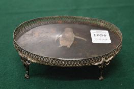 A silver and tortoiseshell small oval tray or stand, the tortoiseshell inset with a silver model