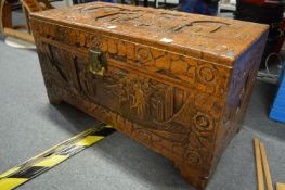 A Chinese carved camphor wood coffer.