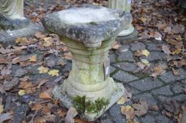 A reconstituted stone pedestal.