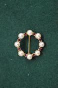 A 9ct gold pearl and garnet circular brooch.