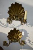 A pair of brass twin branch candle brackets with shell shaped backs.