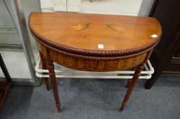 An inlaid mahogany demi-lune fold-over card table.