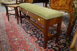 An inlaid mahogany and upholstered long stool.