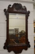 A Georgian design walnut framed fretwork mirror.
