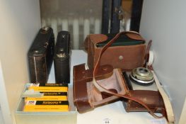 Four old cameras and some film.