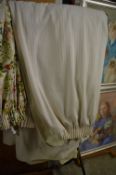 A pair of cream striped curtains, lined, approx size 114cm wide x 195cm long.