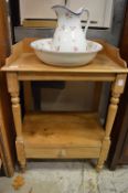 A pine washstand with jug and bowl.