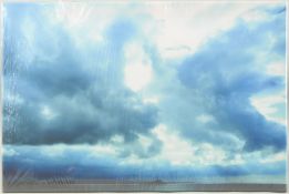 DORA BERTOLUTTI HOWARD (b. 1957). A view of rocky headland beneath breaking skies, canvas print.