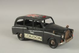 A TIN PLATE LONDON TAXI.