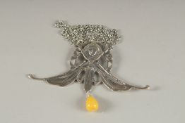 A SILVER NOUVEAU NECKLACE with amber drop.