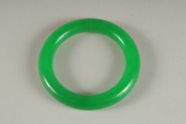 AN APPLE GREEN JADE BANGLE.