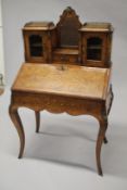 A GOOD VICTORIAN FIGURED WALNUT INLAID BONHEUR DU JOUR WITH MIRROR, the top with brass grill, two