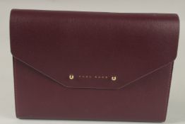 A HUGO BOSS NOTEPAD AND PEN in a burgundy case.