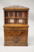 A 19TH CENTURY WALNUT STANDING BOOKCASE, the top with pierced fretwork, single shelf and faux books,