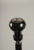 A WOODEN WALKING STICK WITH MERCEDES HANDLE.