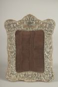 A SILVER .925 PHOTOGRAPH FRAME, with scrolls and birds. 8ins x 5.5ins.