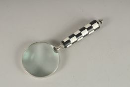 A MAGNIFYING GLASS with chequered handle.