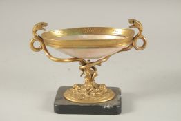 A GRAND TOUR MOTHER-OF-PEARL and GILT METAL TWO HANDLED TAZZA, on a marble base with snake
