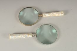 A PAIR OF MAGNIFYING GLASSES with mother-of-pearl handles.