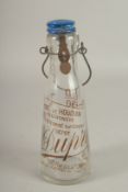 A FRENCH ADVERTISING MILK BOTTLE. 25cms high.