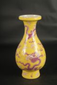 A CHINESE YELLOW GROUND DRAGON VASE.