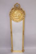 A LOUIS XVITH STYLE LONG NARROW MIRROR with a circular panel of cupids. 70ins long x 29ins wide.