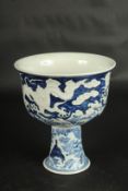 A CHINESE BLUE AND WHITE CARVED DRAGON STEM CUP. 17.5cms high.