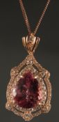 AN 18CT ROSE GOLD PENDANT set with large pear-shaped pink tourmaline surrounded by RBC diamonds with