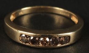 A 9CT YELLOW GOLD 5-STONE NATURAL CINNAMON DIAMOND RING, channel set. RBC diamonds 0.45ct approx.