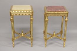 TWO MARBLE TOP SQUARE GILTWOOD TABLES, on fluted legs with under-tier. 28ins high x 15ins square.