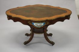 A GOOD 19TH CENTURY KINGWOOD LEATHER TOP OVAL TABLE, the sides with Sevres porcelain panels,