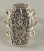 A SILVER COFFIN RING.