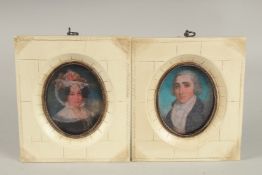 A PAIR OF GEORGIAN STYLE MINIATURES of a gentleman and lady.