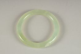 A CELADON ICY JADE BANGLE.