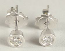 A PAIR OF 18CT WHITE GOLD AND DIAMOND EAR STUDS. 0.45ct.
