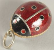 A SILVER LADYBIRD PENDANT.