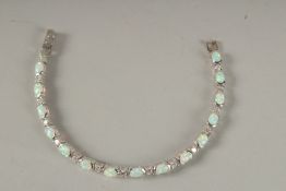 A SILVER AND OPAL LINE BRACELET.