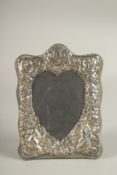 A SILVER HEART SHAPED PHOTOGRAPH FRAME. 8ins x 5.5ins.