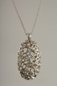 A MODERNIST SILVER LOCKET on a chain.
