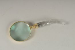 A MAGNIFYING GLASS with a cut glass handle.